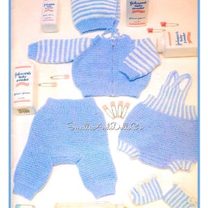 May include: A blue and white striped baby outfit with a matching hat, pants, and a bib. The outfit is laid out on a white surface with baby powder and a baby bottle.
