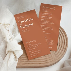 May include: A rust-colored wedding ceremony program with white text. The program lists the wedding party, the officiant, and the order of the ceremony. The text includes the names Christine and Richard, the date 04.18.2027, and the location Newport, RI.