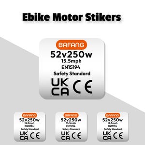 Può includere: Tre adesivi bianchi con testo nero e accenti arancioni. Ogni adesivo riporta la scritta "BAFANG 52v250w 15.5mph EN15194 Safety Standard UK CA CE".