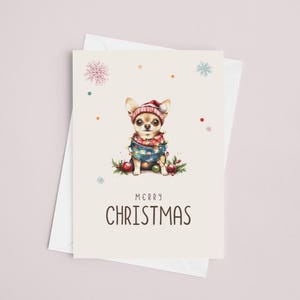 May include: A Christmas card featuring a cartoon chihuahua wearing a red and white Santa hat and a blue and red scarf with Christmas lights. The card has a white background with red and blue snowflakes and dots. The text "Merry Christmas" is printed in black at the bottom of the card.