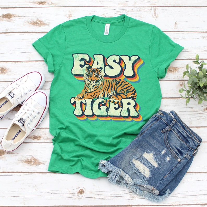 May include: Green t-shirt with a retro-style graphic of a tiger and the text "Easy Tiger".