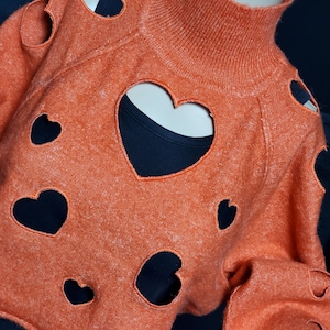 LAST OF Orange Cropped Lightweight Womens Mock Neck Sweater with cut out hearts embroidered sealed