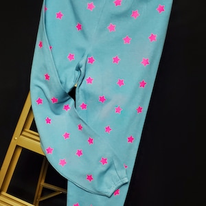 Aqua sweatpants, dyed prewashed with pink fluorescent/glow in the dark stars on legs front and back