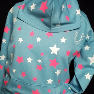 Aquamarine, starry hoodie with horseshoe. Glow in the dark and fluorescent stars and horseshoe. Black light affects Dyed and Prewashed
