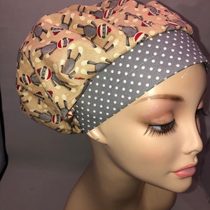 May include: A tan and gray scrub hat with a monkey print on the tan fabric and white polka dots on the gray fabric.