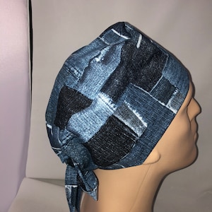 May include: A blue and black patterned surgical scrub hat with a tie. The pattern resembles denim fabric.