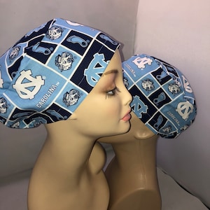 May include: Two blue and white patterned surgical caps with the University of North Carolina Tar Heels logo and the text "Carolina TM".