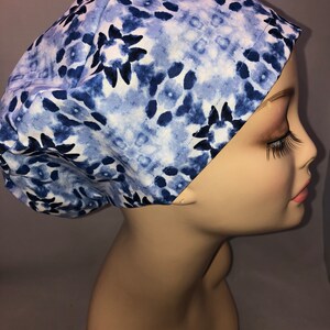 May include: A blue and white patterned scrub hat with a tie-dye design. The hat is made of a soft, comfortable fabric and is perfect for nurses, doctors, and other healthcare professionals.