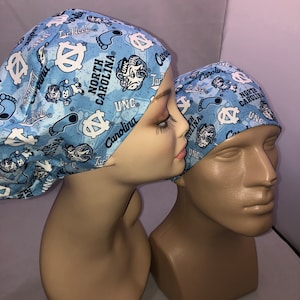 May include: Two blue and white patterned surgical caps with the text "Tar Heels", "UNC", and "North Carolina" printed on them.
