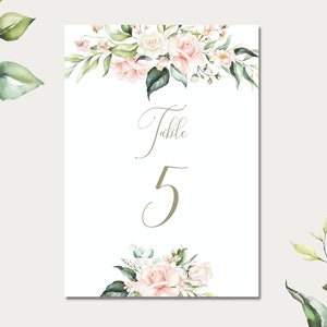 May include: A white card with a floral design and the text "Table 5" in a cursive font. The flowers are pink and white with green leaves.