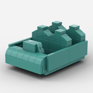 May include: A teal-colored toy car constructed from interlocking plastic bricks. The car features a rounded front, an open interior, and a series of rectangular blocks forming the back. The design is reminiscent of a classic convertible.