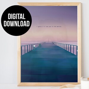 May include: A digital download of a print featuring a pier extending into a body of water at sunset. The sky is a gradient of pink, purple, and blue. The text "I guess I'll see you in the movies." is printed in white at the top of the image.