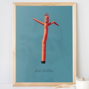 May include: A red inflatable tube man with a smiling face and outstretched arms. The background is a light blue color. The text below the tube man reads "What's a bad miracle? They got a word for that?"