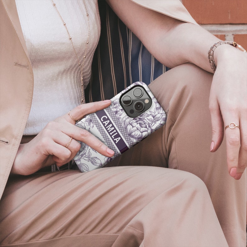 a woman sitting on a bench holding a cell phone