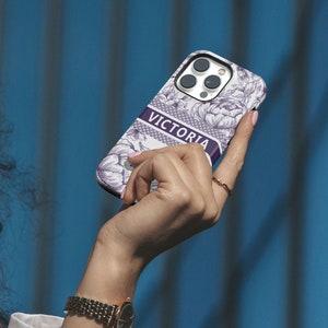 a woman holding a cell phone up to her face