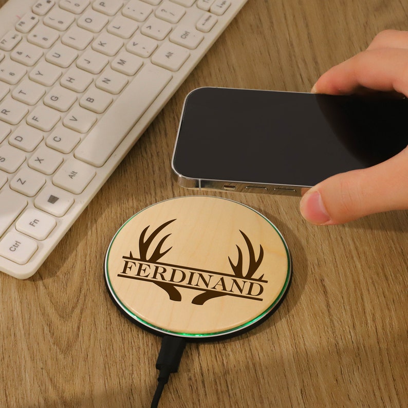 a person holding a cell phone near a keyboard