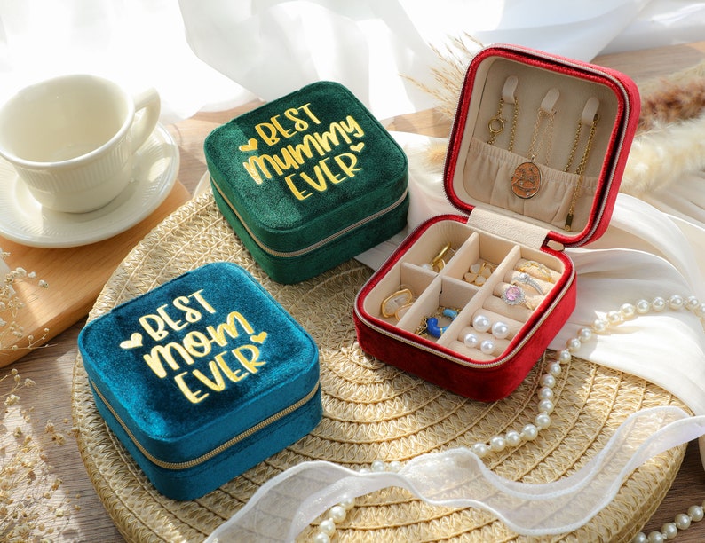 three small jewelry boxes sitting on top of a table