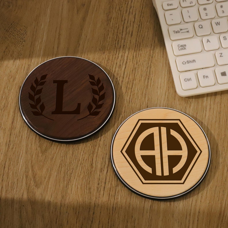 two wooden coasters sitting on top of a wooden desk