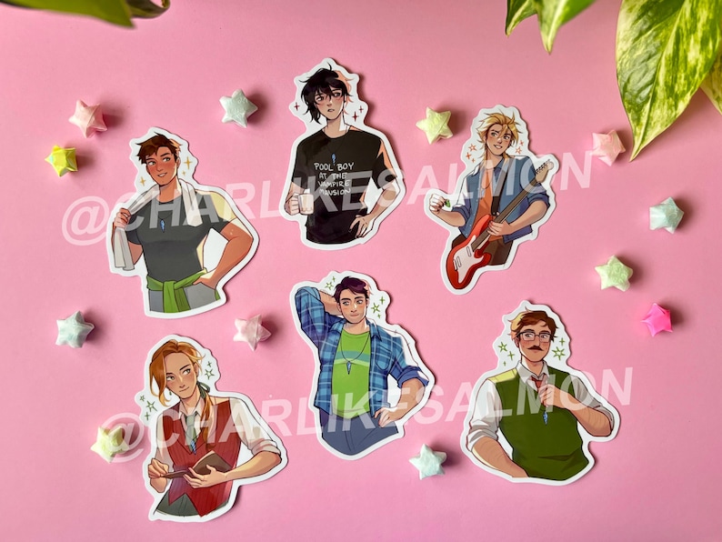 May include: A collection of die-cut stickers featuring illustrations of various characters. The stickers showcase individuals in diverse outfits and poses, with a pink background and star-shaped decorations. The text "POOL BOY AT THE VAMPIRE MANSION" is visible on one sticker.