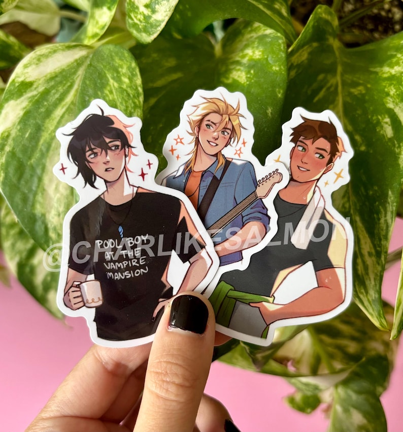 May include: Three stickers featuring anime-style illustrations of male characters. One holds a mug, another a guitar, and the third has a towel around his neck. The stickers have a white border and star accents. Text on one sticker reads "POOL BOY AT THE VAMPIRE MANSION".