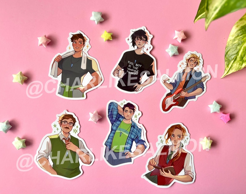 May include: A collection of six stickers featuring stylized illustrations of male characters. The characters are depicted in various outfits and poses, with some holding objects like a guitar or a coffee cup. The stickers are arranged on a pink surface with origami stars.