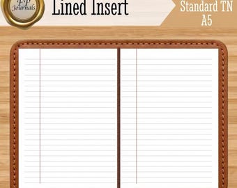 May include: A notebook with a brown leather-like cover and white lined pages. The text "FP Journals", "Lined Insert", and "A6 Standard TN A5" is visible. The interior shows two open pages with horizontal lines and a vertical margin line on each side.