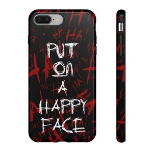 Könnte beinhalten: Schwarze Handyhülle mit einer roten und weißen Grafik, auf der "Put on a happy face" steht, vor einem Hintergrund aus roten "Ha"-Kritzeleien.