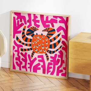 May include: A framed print of a colorful abstract illustration of a crab on a pink background with pink and white abstract shapes.