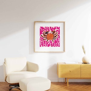 May include: A framed print of a colorful abstract illustration of a crab on a pink background.