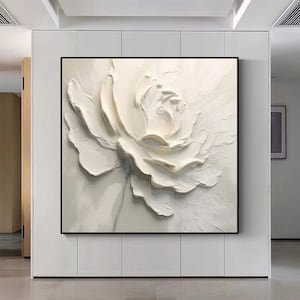 May include: A white abstract painting of a flower with textured brushstrokes. The flower is in the center of the canvas and is the main focus of the painting.