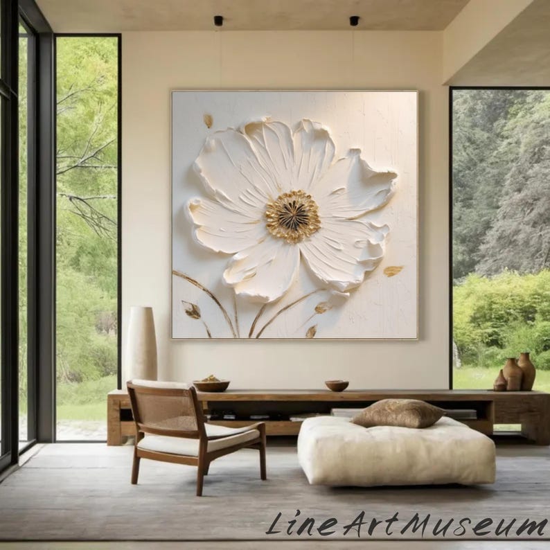 May include: A large, textured white flower painting with a gold center and delicate gold accents. The artwork is displayed in a light-colored room with a wooden bench, chair, and a large window. The text "Line Art Museum" is at the bottom.