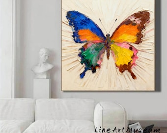 May include: A vibrant, textured painting of a butterfly with wings in shades of blue, orange, yellow, green, and brown. The artwork features a textured background with radiating lines, creating a sense of movement. The painting is displayed on a wall.