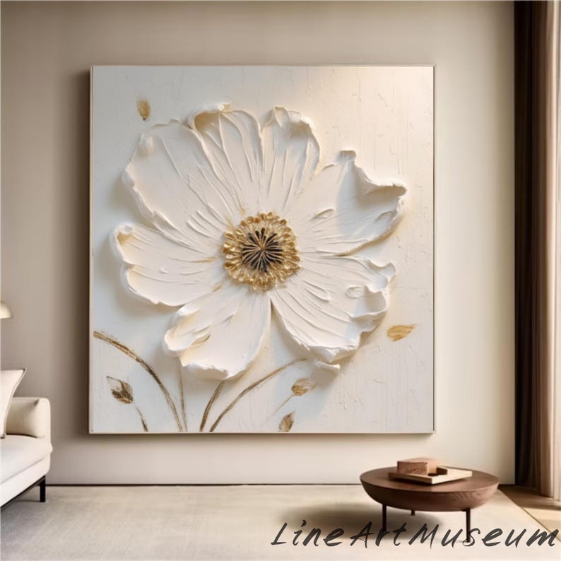 May include: Large, textured white flower art piece with a gold center and accents. The artwork is mounted on a square, off-white canvas. The words "Line Art Museum" are at the bottom.