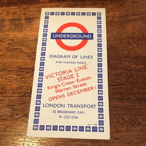 May include: A white and blue London Underground poster announcing the opening of Stage 2 of the Victoria Line in December 1968. The poster features the iconic London Underground logo and the text "Victoria Line Stage 2 King's Cross-Euston Warren Street Opens December 1 London Transport 55 Broadway, S.W.I 01-222 1234 No. 3 1968"