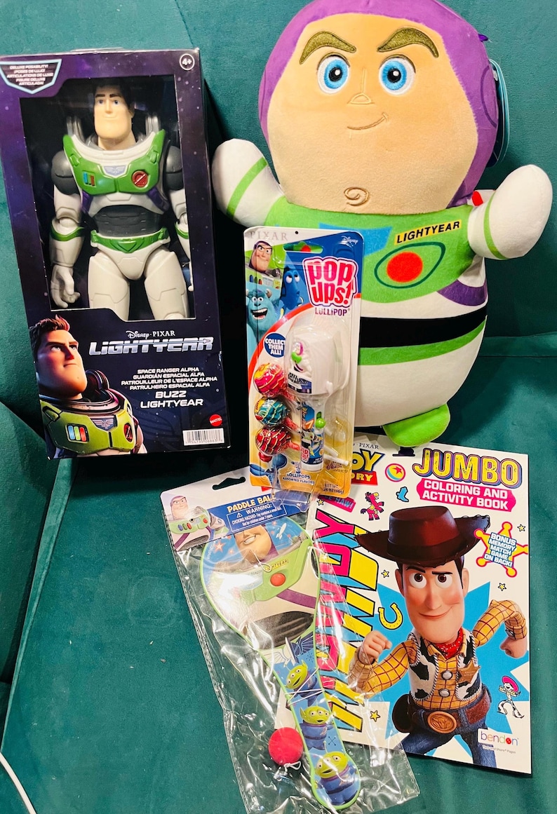 May include: A collection of Disney Pixar Lightyear toys and merchandise. Includes a Buzz Lightyear action figure, a plush toy, a coloring book, a paddle ball game, and a lollipop pack. The items feature vibrant colors and character designs.