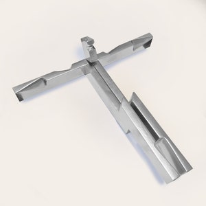 May include: A silver metal puzzle in the shape of a cross. The puzzle is made up of several interlocking pieces.
