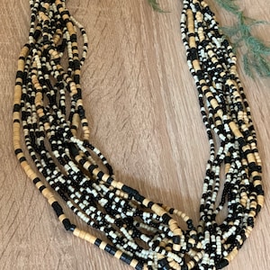 Zeer interessante multi streng zwart en beige houten heishi kralen en zwart en wit zaad kralen lange verstelbare boho stijl ketting