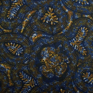 May include: Detailed fabric with a repeating pattern in navy, black, and gold. The design features paisley-like shapes and leaf motifs, creating a textured appearance. The fabric has a dark, rich colour palette, suitable for various textile projects.