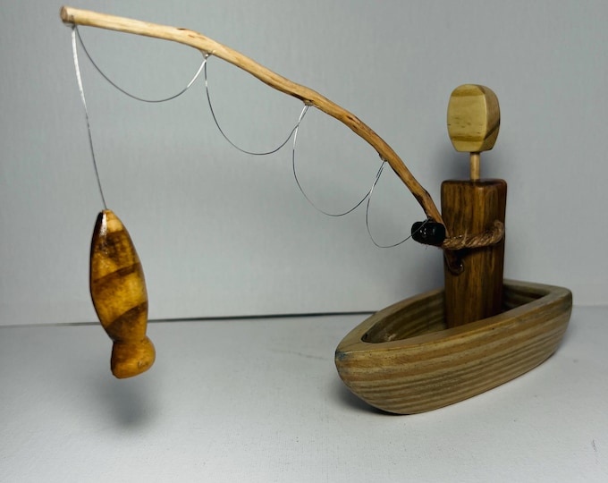 Fisherman in boat faceless wood figurine