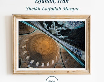 May include: A framed wall art print featuring the interior dome of the Sheikh Lotfollah Mosque in Isfahan, Iran. The image displays intricate blue and gold tile patterns, a golden geometric ceiling, and text reading Isfahan, Iran Sheikh Lotfollah Mosque.