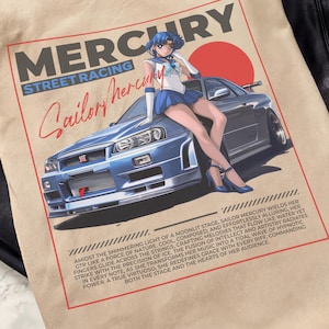 May include: Beige t-shirt featuring a graphic of a blue sports car with a Sailor Mercury anime character. The design includes the words "MERCURY STREET RACING" and "Sailor Mercury" in red and white.