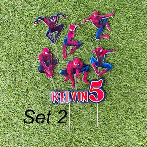 May include: Set of 7 red and blue Spiderman cake toppers with the name Kelvin and the number 5. The toppers are on sticks and are ready to be placed on a cake.