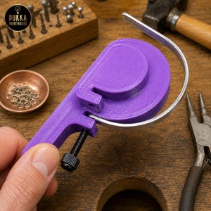 May include: A purple 3D-printed wire bending tool featuring a curved metal guide and a black adjustable screw mechanism. The device is designed for shaping wire into circular forms and includes a handle for manual operation during jewelry making.
