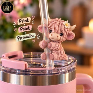 May include: A pink tumbler with a clear straw featuring a sculpted, fuzzy pink Highland cow topper with a small white flower on its head. The text Print, Paint, Personalise is displayed in a stacked format next to the cow figure.