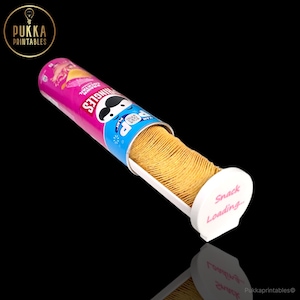 May include: A Pringles potato chip container, with a pink and blue label, is open, revealing a stack of chips. The container has the Pringles logo and the words "Snack Loading..." on the white dispenser.