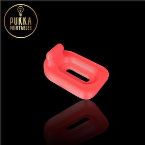 May include: A bright red 3D printed object shaped like a small inflatable pool float with a raised lip on one side. The object has a smooth, slightly textured surface.