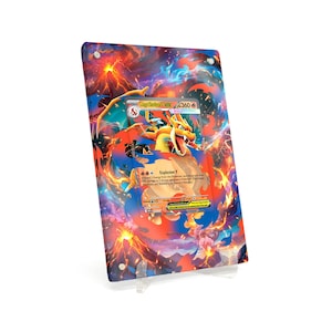 May include: A framed Pokémon trading card featuring Charizard EX. The card has a fiery background with orange, red, and blue hues. The card is displayed on a clear acrylic stand.