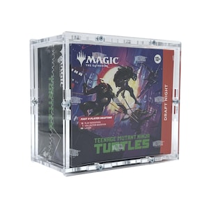 May include: A transparent acrylic display case containing a box of Magic: The Gathering cards. The box has Teenage Mutant Ninja Turtles graphics and the words "Draft Night". The case is fastened with small silver screws.