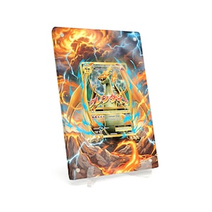 May include: A framed Charizard Pokémon card, featuring a fiery background with orange and yellow hues, and blue lightning accents. The card itself displays a detailed illustration of Charizard with Japanese text and the words "Crimson Dive".