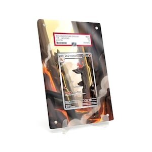 May include: A graded Charmeleon card displayed in a clear acrylic holder. The card features a fiery landscape background and the name "Charmeleon" at the top. A red and white label is visible with the text "2036 GRADED CARD ENGLISH".